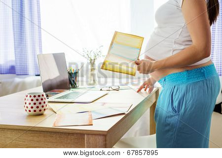 Pregnant woman working from home