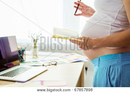 Pregnant woman working from home