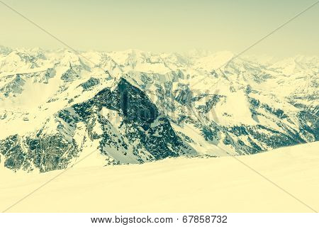 Snow Covered Slope With Mountain Ridge In The Back