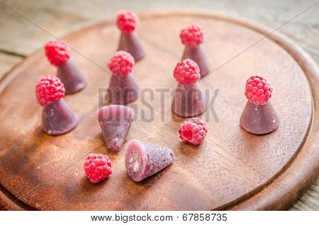 Cuberdons With Fresh Raspberries On The Wooden Board