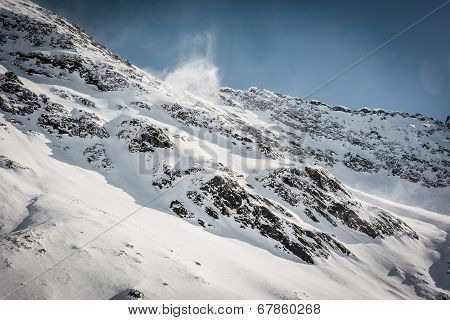 Mountain Ridge With Wind Blowing Off Some Snow