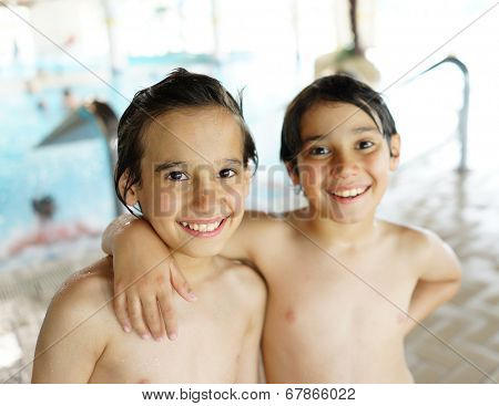Happy little boys enjoying relaxing and splashing in water
