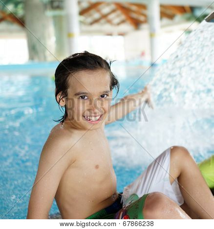 Happy little boys enjoying relaxing and splashing in water
