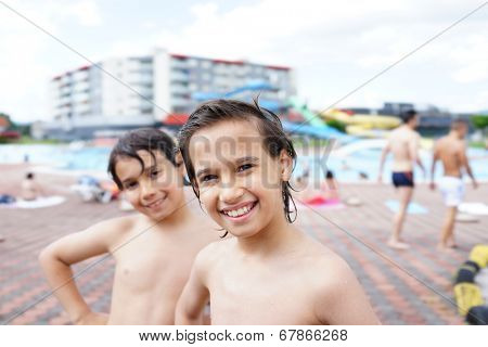Happy little boys enjoying relaxing and splashing in water