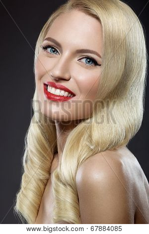 Beautiful blonde woman with evening make-up and red lips.