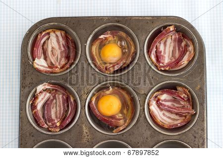 Raw Bacon And Eggs In A Muffin Pan