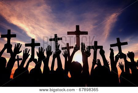 Group of People Holding Cross and Praying in Back Lit