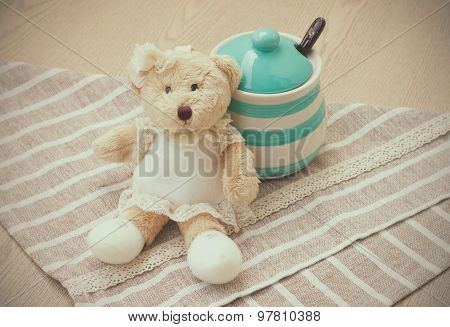 Green pastel porcelain jar and little bear doll in vintage style.