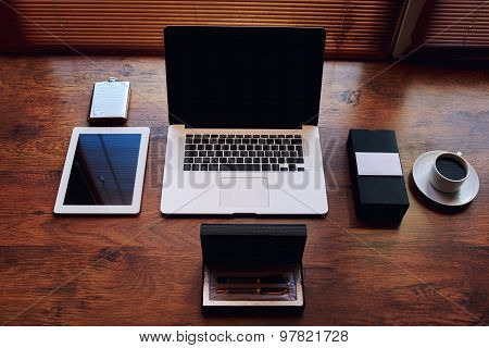 ?omputer and digital tablet with blank copy space screen in private office table of wealthy person