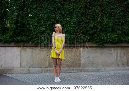 Female cute hipster girl standing against blank copy space for your text message or content