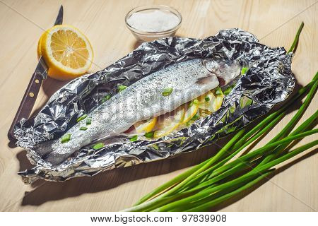 Baked In Foil Fish On A Wooden Table