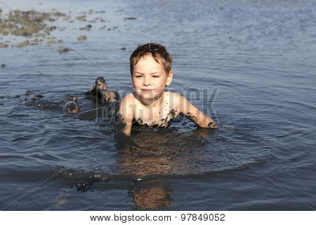Kid Lying In The Healthy Mud