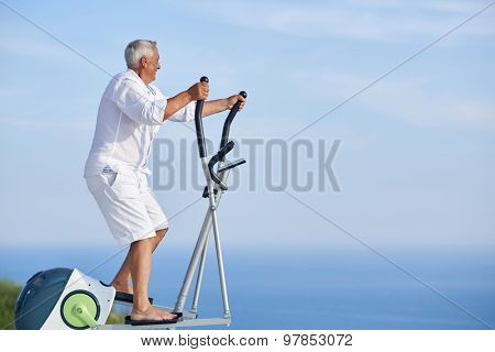 healthy senior man working out on gym treadmill machine at modern home terace with ocean view