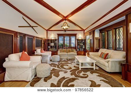 Authenic Living Room With Brown And White Decorative Rug.