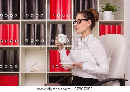 Business woman sitting with cup of coffee