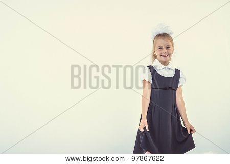 Cheerful school girl standing