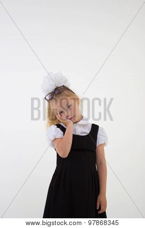 Schoolgirl with glasses standing worried