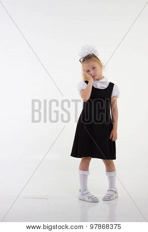 Schoolgirl with glasses standing worried