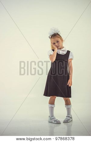 Schoolgirl with glasses standing worried