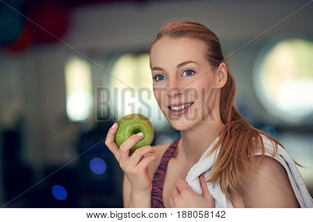Attractive Young Woman Athlete Holding An Apple