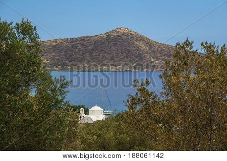 A small white church on the shore of the Gulf of Mirabello. Crete. Greece