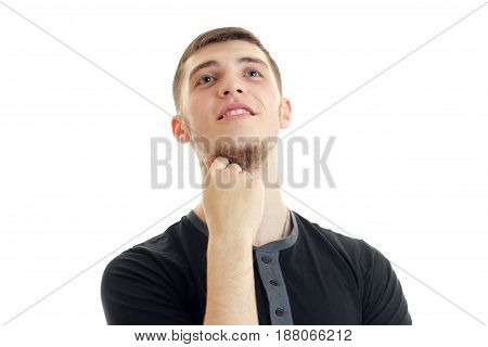 cute young guy smiling raised my head up and keeps your hand near the Chin close-up isolated on white background