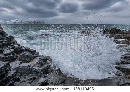 Ocean Waves Splasshes and Roaring Water on Beach At Lofoten Islands in Norway.Horizontal Image Composition