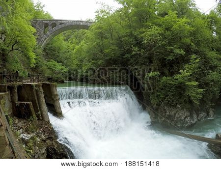 beautiful waterfall among green forest in Slovenia Blejski Vintgar