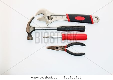 Hand tools with Adjustable Wrenches hammers screwdrivers and pliers on white backgrounds