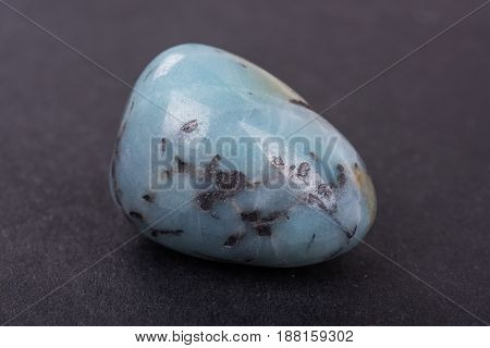 Amazonite geode on black background. Beautiful natural crystal gemstone.