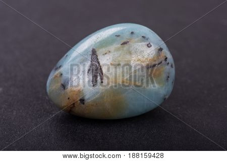 Amazonite geode on black background. Beautiful natural crystal gemstone.