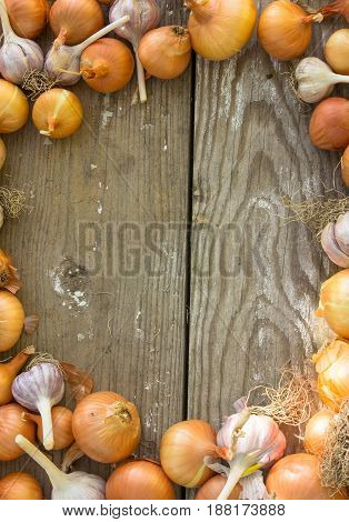 Close-up organic onion garlic bulbs and garlic cloves on wodeen background. . bulbs. Onion Garlic cloves on wooden vintage door.flat lay style