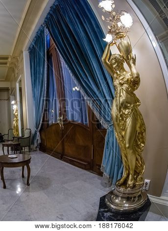 MOSCOW RUSSIA - APRIL 27 2017: Statue floor lamp and decorative door in Metropol hotel in Moscow Russia on April 27 2017. Hotel was built in 1899-1907 in Art Nouveau style.
