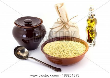 Dry Millet In Ceramic Bowl Isolated On White. Spilled Millet.