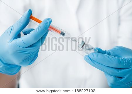 Injection of the vaccine into the syringe by a doctor.