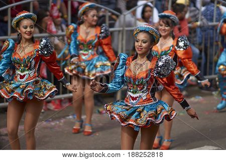 ORURO, BOLIVIA - FEBRUARY 26, 2017: Caporales dancers in ornate costumes performing as they parade through the mining city of Oruro on the Altiplano of Bolivia during the annual carnival.