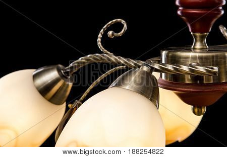 Modern Chandelier for interior decoration of the living room. Bronze Chandelier details close-up isolated on black background.