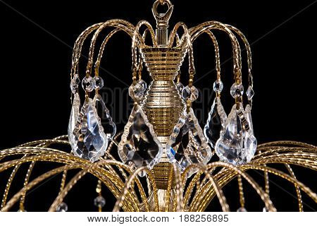 Chandelier for interior of the living room. chandelier details decorated with crystals isolated on black background. Close-up photo