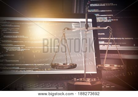 Justice Weight Scales With Code On Monitor In Background