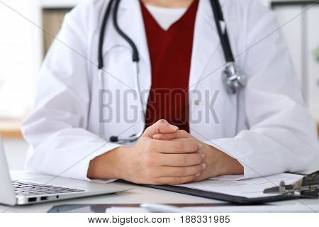 Close up of a unknown female doctor's hands. Physician is ready to consult and halp patients. Medicine and health care concept