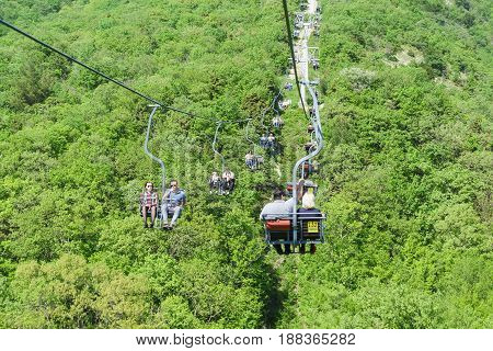 Gelendzhik Russia - April 30.2017: Tourists climb and descend by cable car over the spring and the of the Markotkh mountain range in the Safari Park.