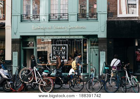Amsterdam Netherlands - August 09 2016. Asian restaurant with bicycles in storefront in Oude Pijp a neighborhood in Amsterdam.