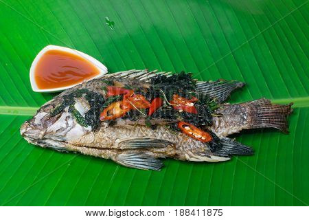 Fried fish (Tilapia) isolate banana leaf,thai food