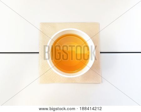 Morning Tea form Top View Like an Egg on the White Table with Brown Tissue