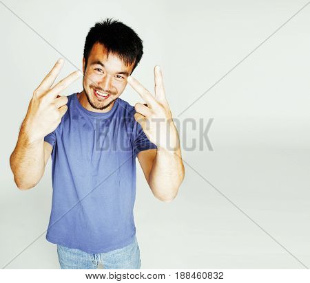 young cute asian man on white background gesturing emotional, pointing, smiling, lifestyle people concept, cheerfull mature guy making funy faces close up