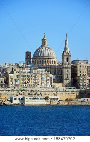 VALLETTA, MALTA - MARCH 30, 2017 - View of St Pauls Anglican Cathedral and the Basilica of Our Lady of Mount Carmel seen from the Grand Harbour Valletta Malta Europe, March 30, 2017.