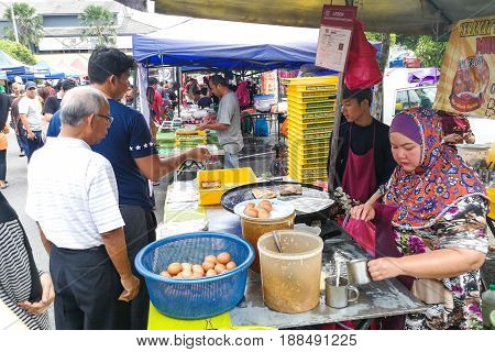 Kuala Lumpur, Malaysia, May 29, 2016: Muslim Shopper Buying Food From Street Vendor For Breaking Fas