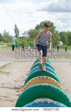 A Teenager In A T-shirt Is Engaged On The Obstacle Course