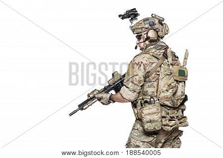 Elite member of US Army rangers in combat uniforms with his shirt sleeves rolled up, in helmet, eyewear and night vision goggles. Studio shot, white background