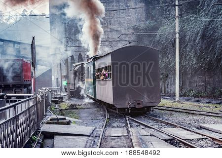 Yuejin Sichuan province China November 03 2016: Steam narrow-gauge train with local people moves to Bagou.